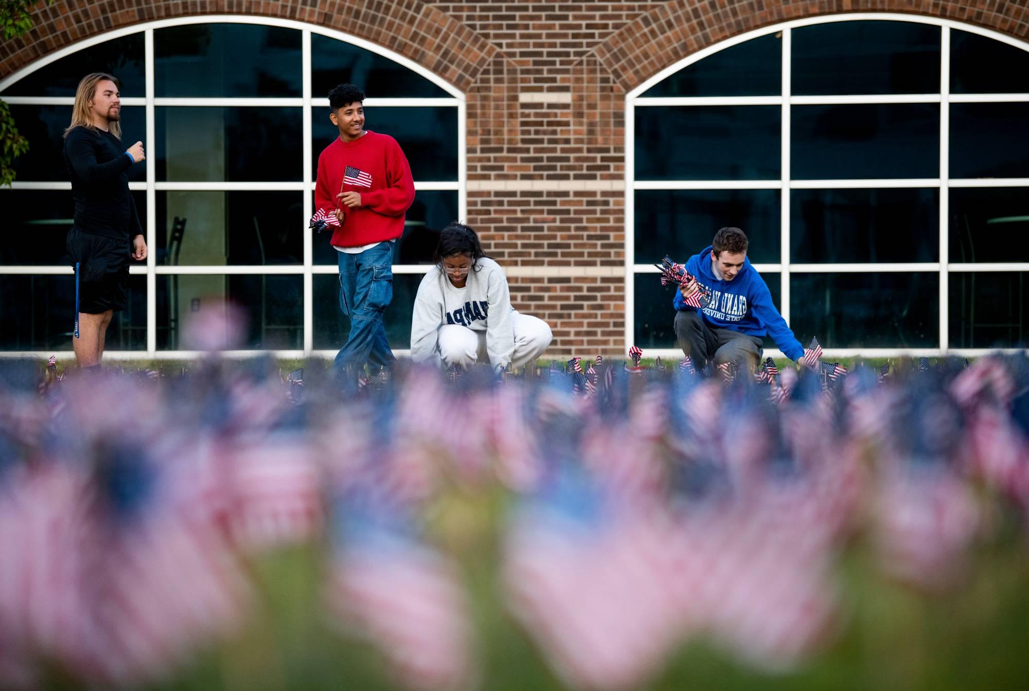 Several Student Senators putting up flags in the Kirkhof lawn as a memorial for the 9/11 attacks.